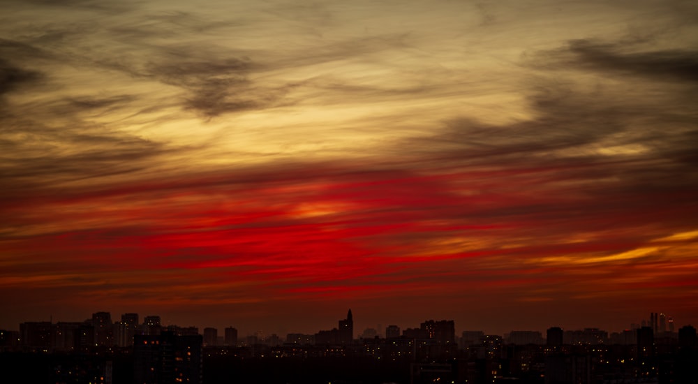 a red and yellow sunset over a city