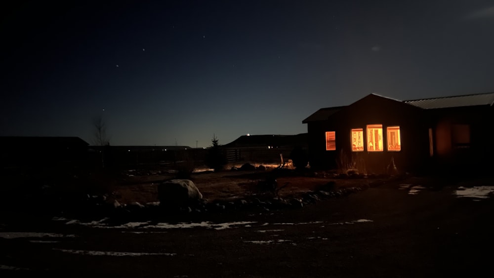 a house lit up at night in the dark