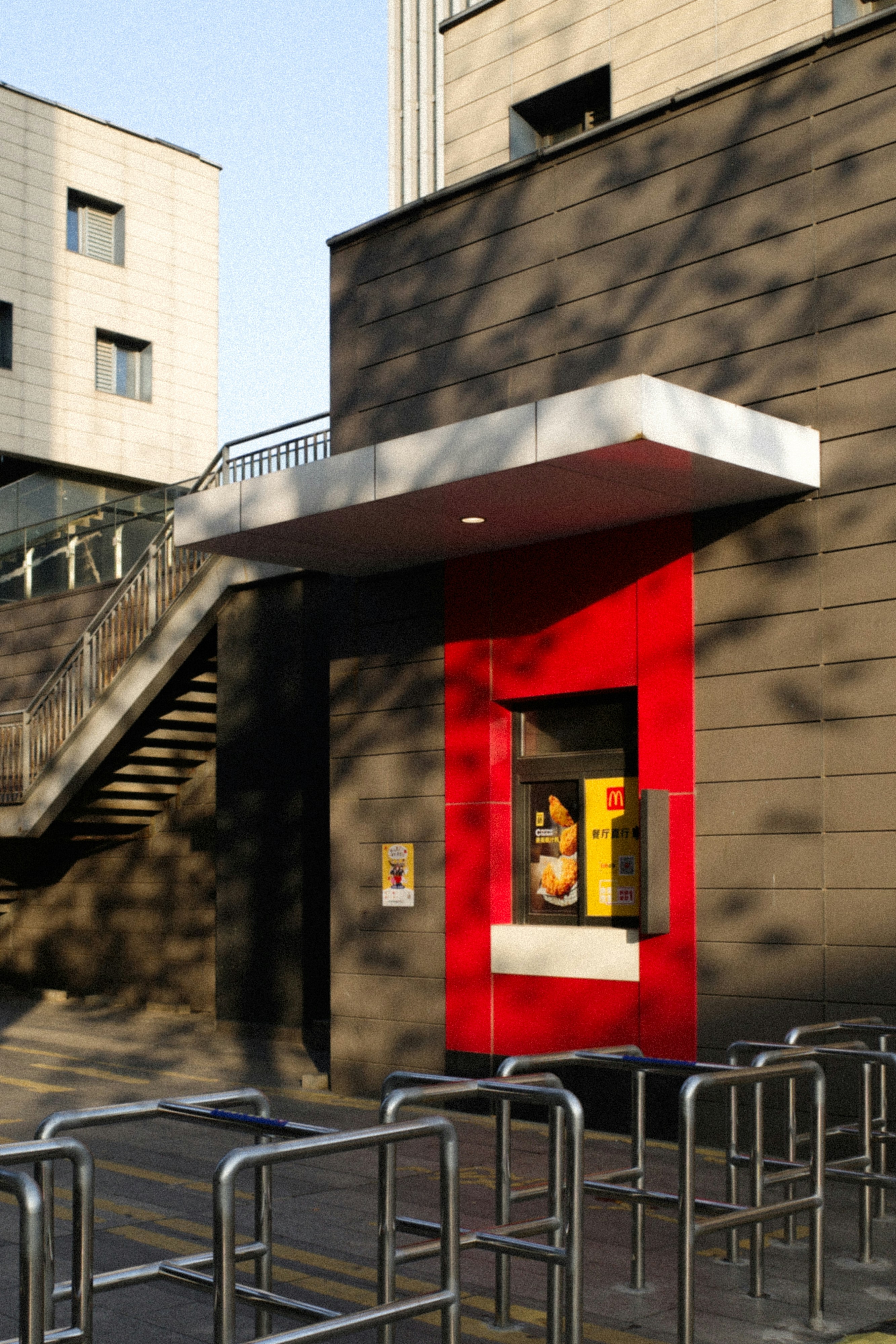 a red and white building with a red and white awning