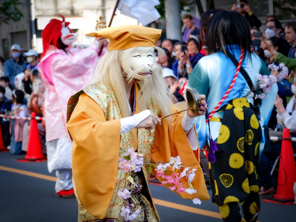 a group of people in costume walking down a street
