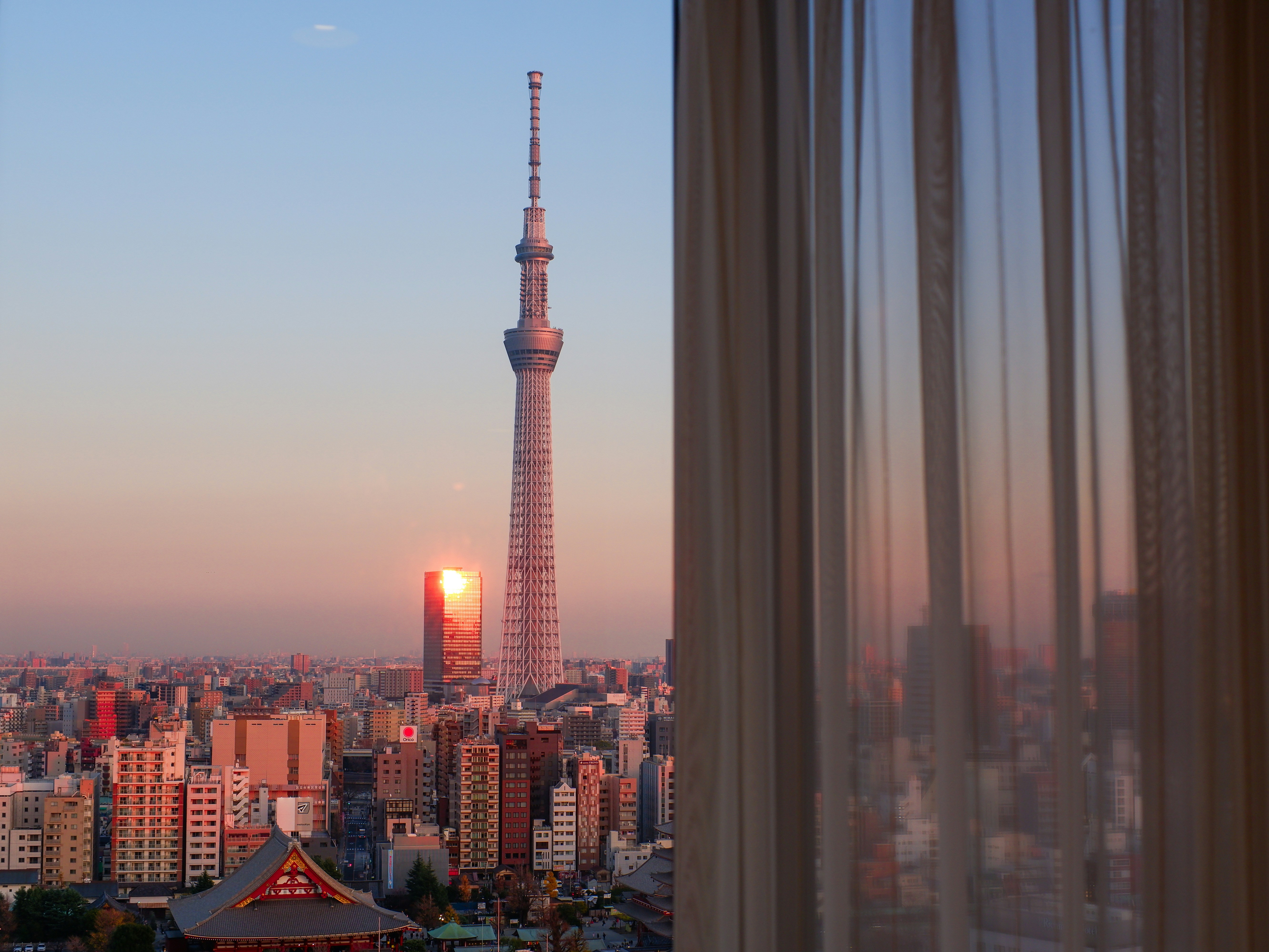 a view of a city at sunset from a window