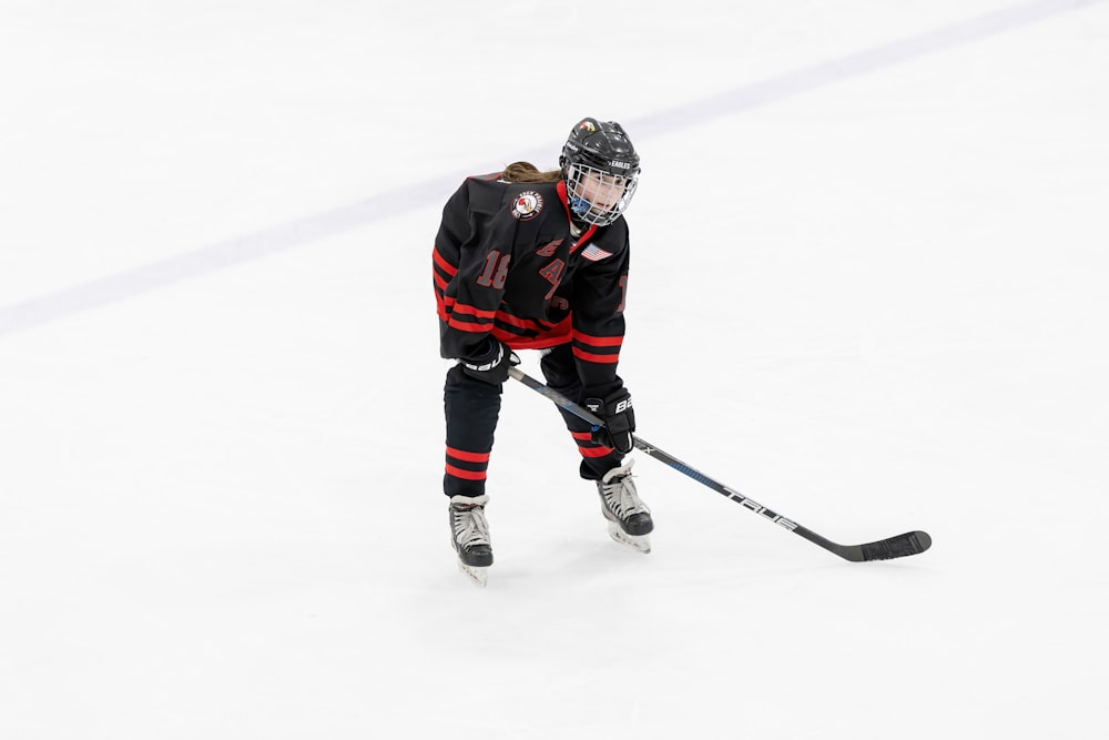 a female ice hockey player in action on the ice