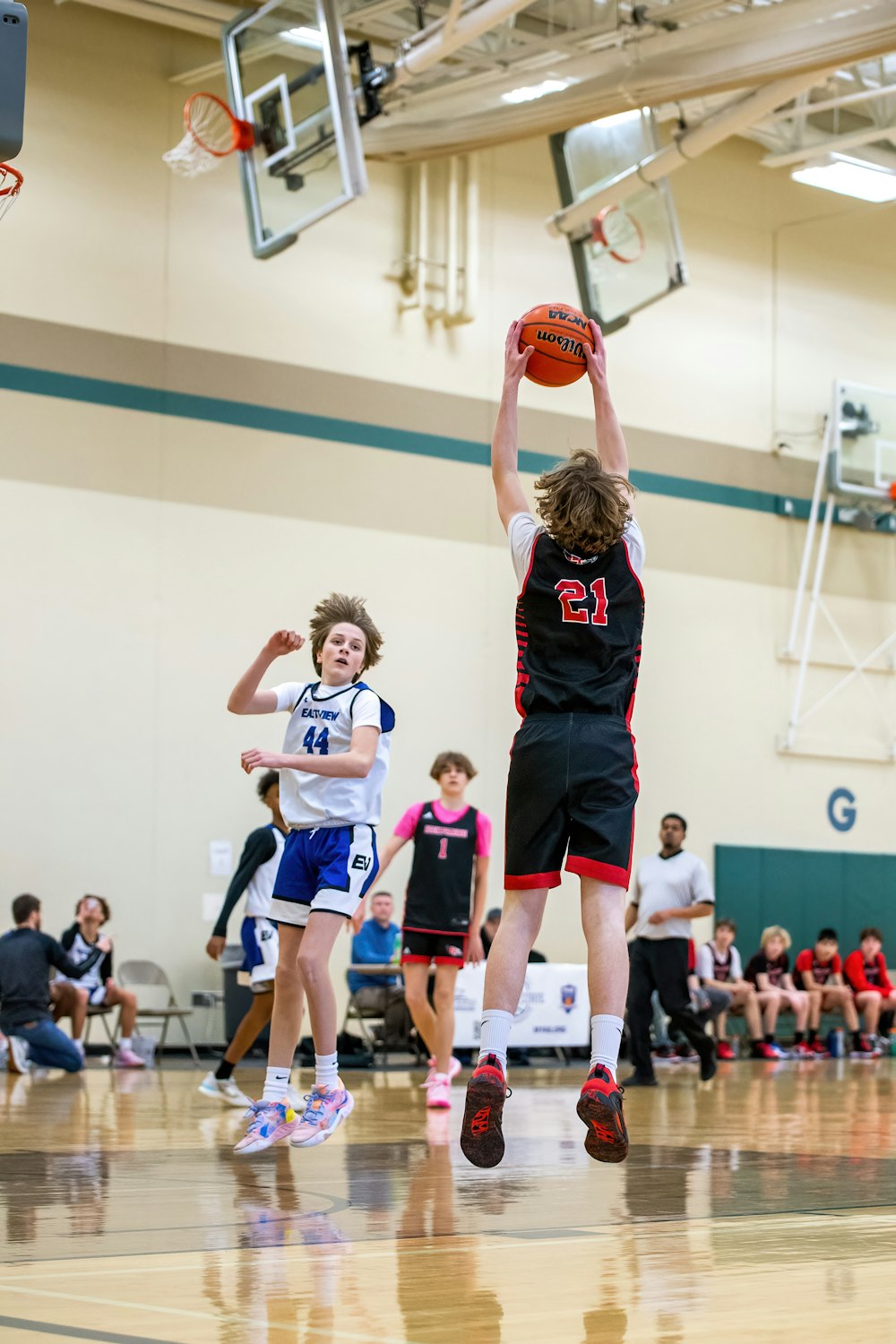 a group of young men playing a game of basketball