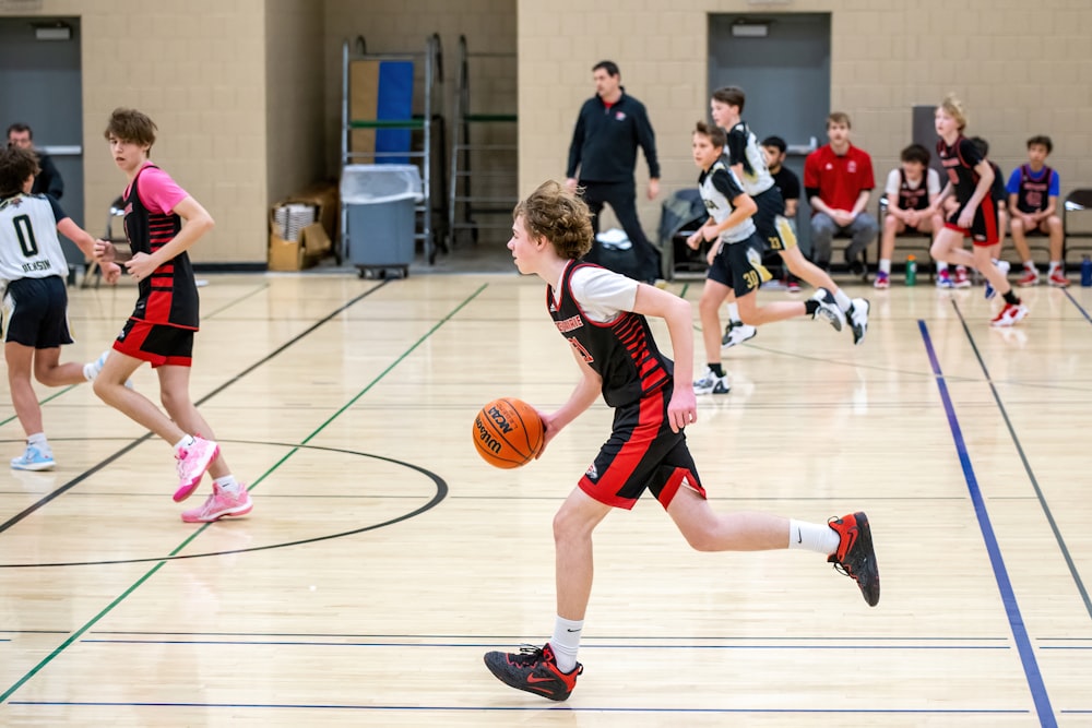 a group of young people playing a game of basketball