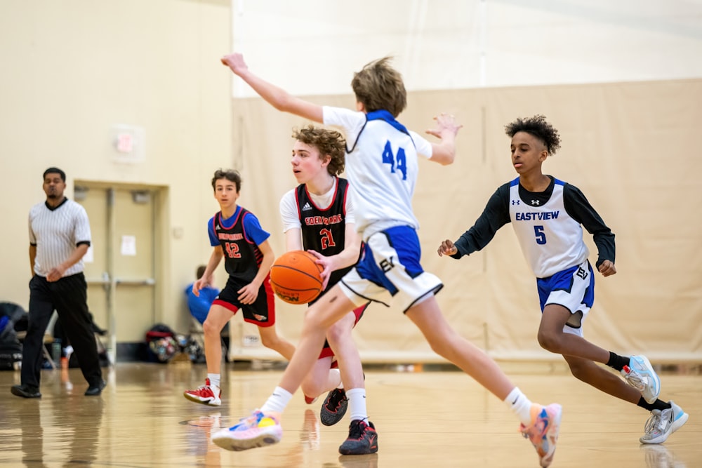 a group of young men playing a game of basketball