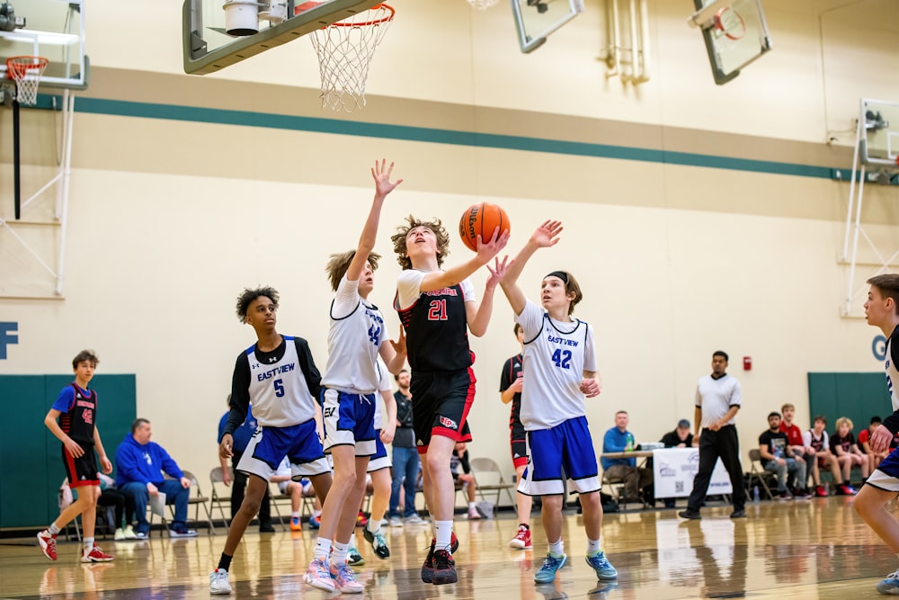 a group of young men playing a game of basketball