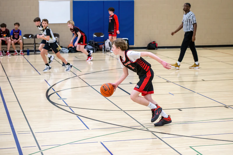 A group of young men playing a game of basketball