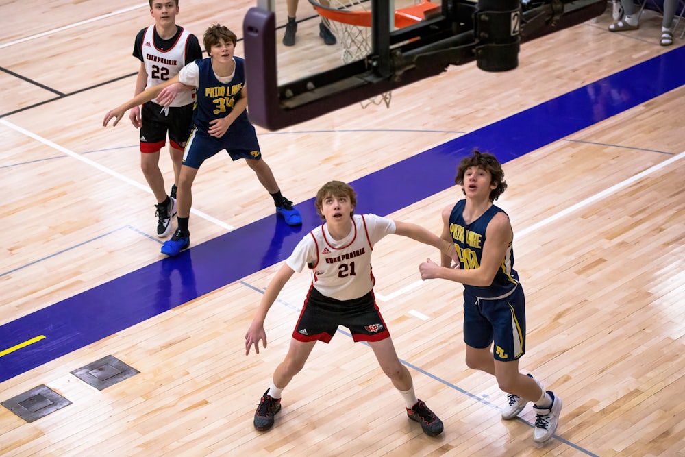 a group of young men playing a game of basketball