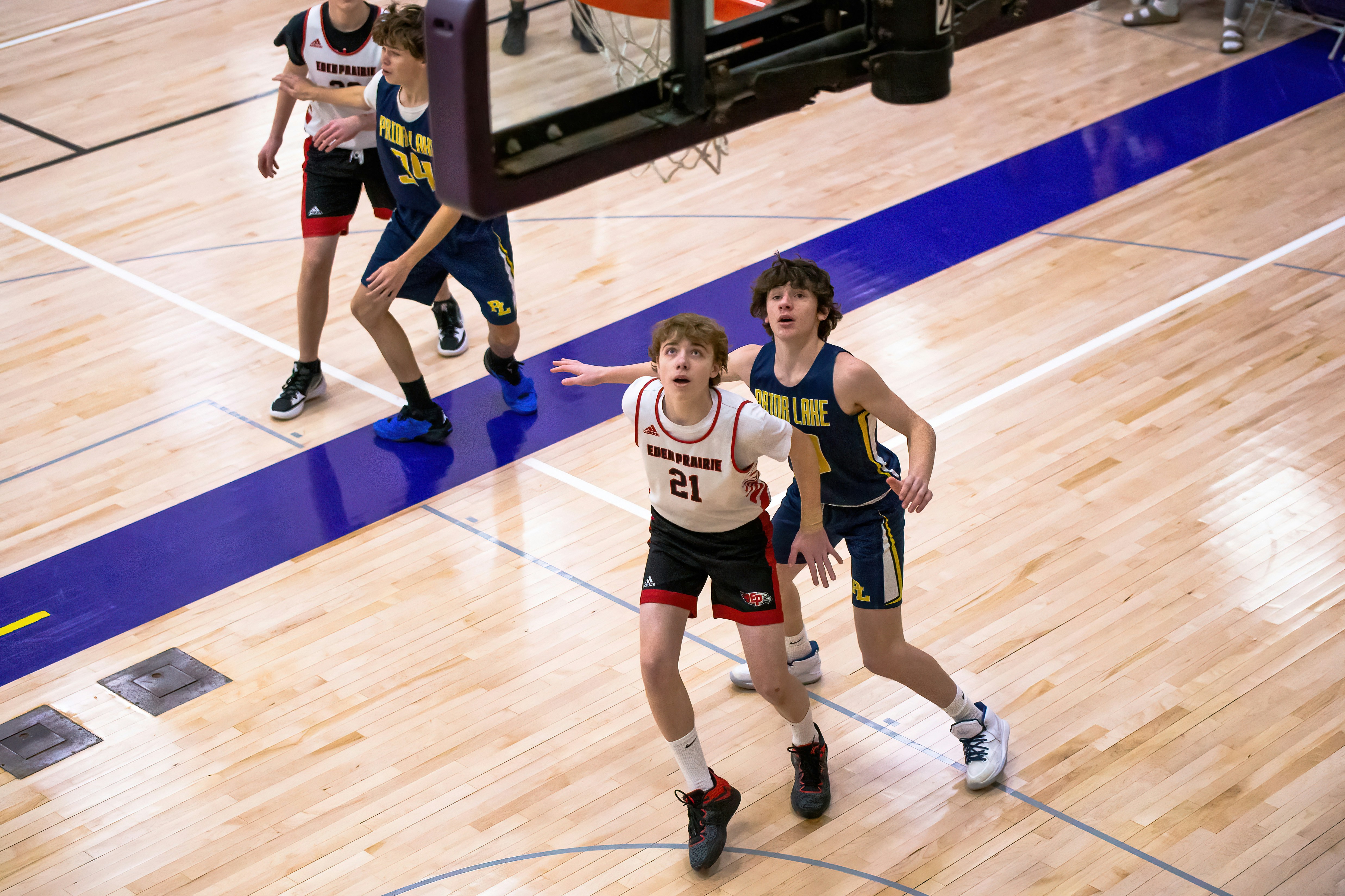 a group of young men playing a game of basketball
