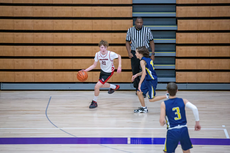 A group of young men playing a game of basketball