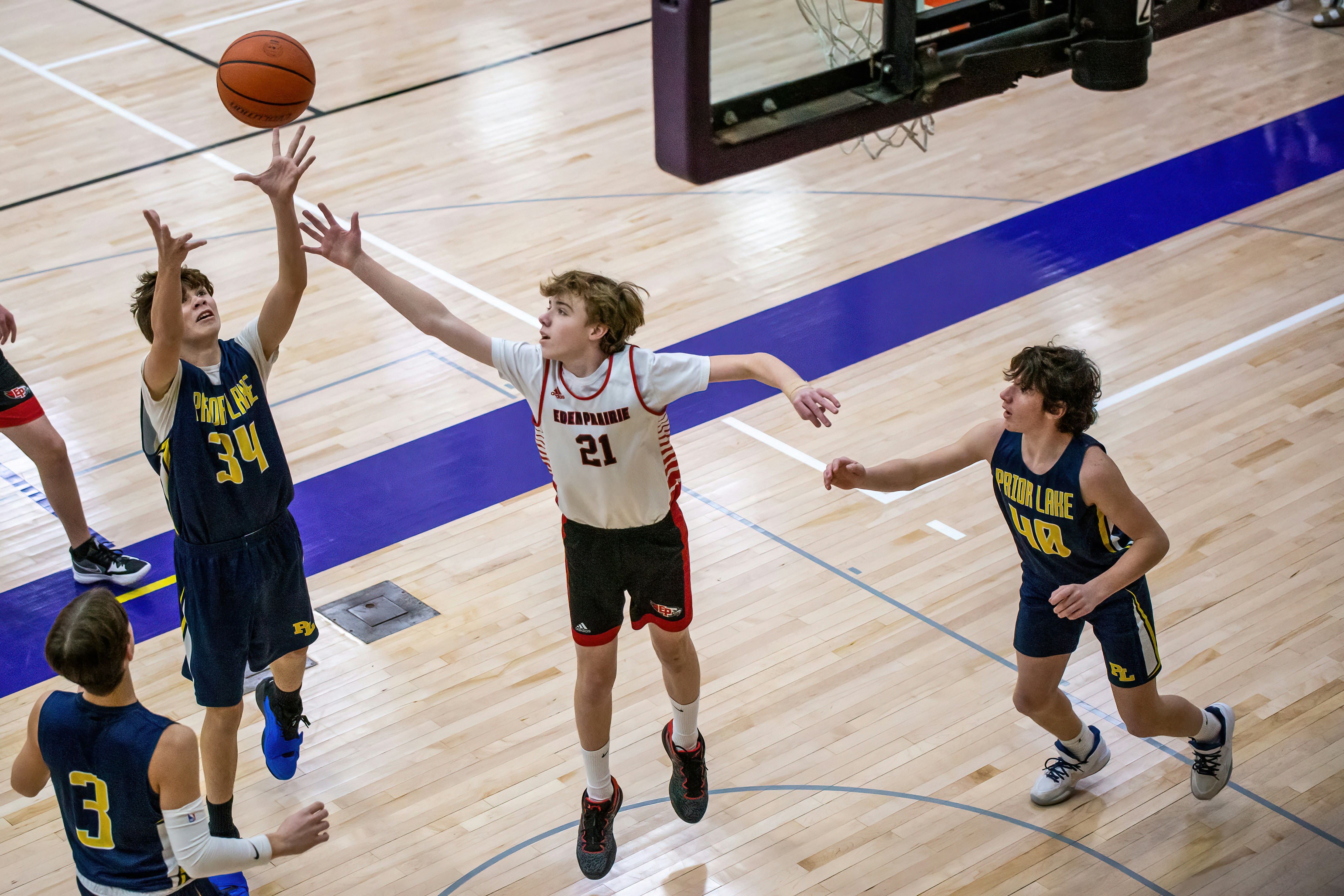 a group of young men playing a game of basketball