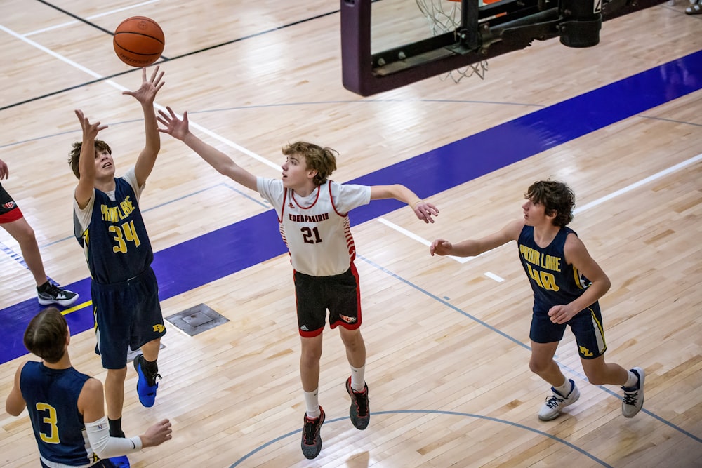 a group of young men playing a game of basketball