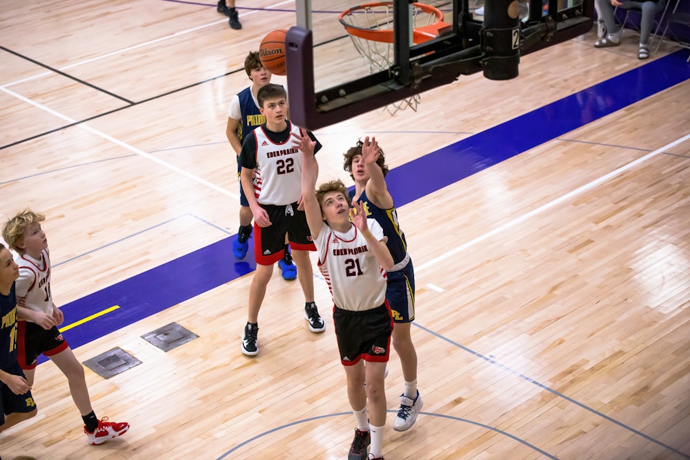 a group of young men playing a game of basketball