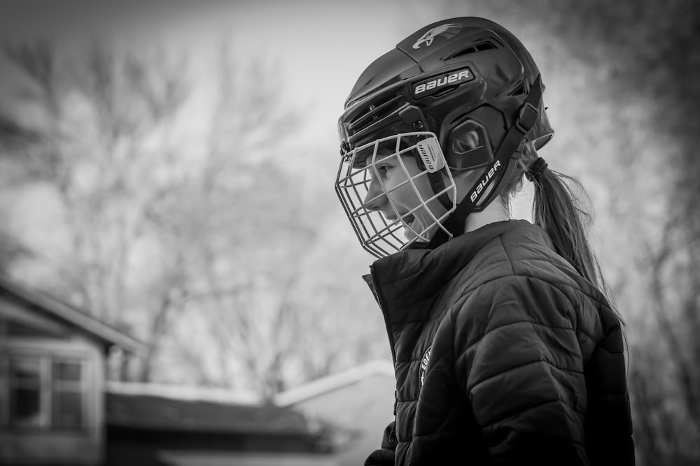 a young girl wearing a helmet and protective gear