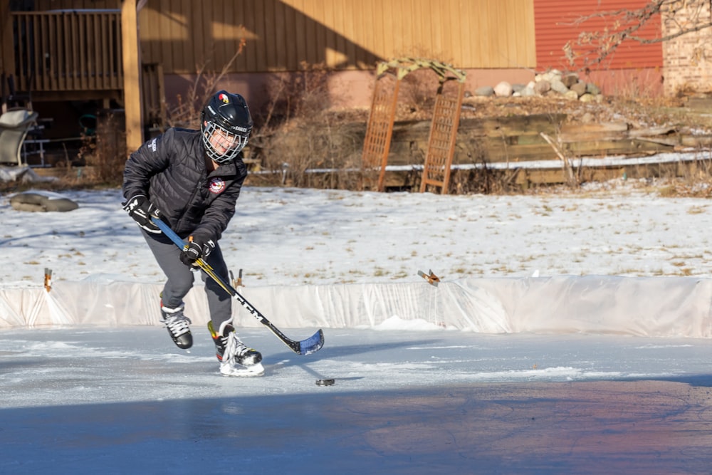 a young man is skating on an ice rink