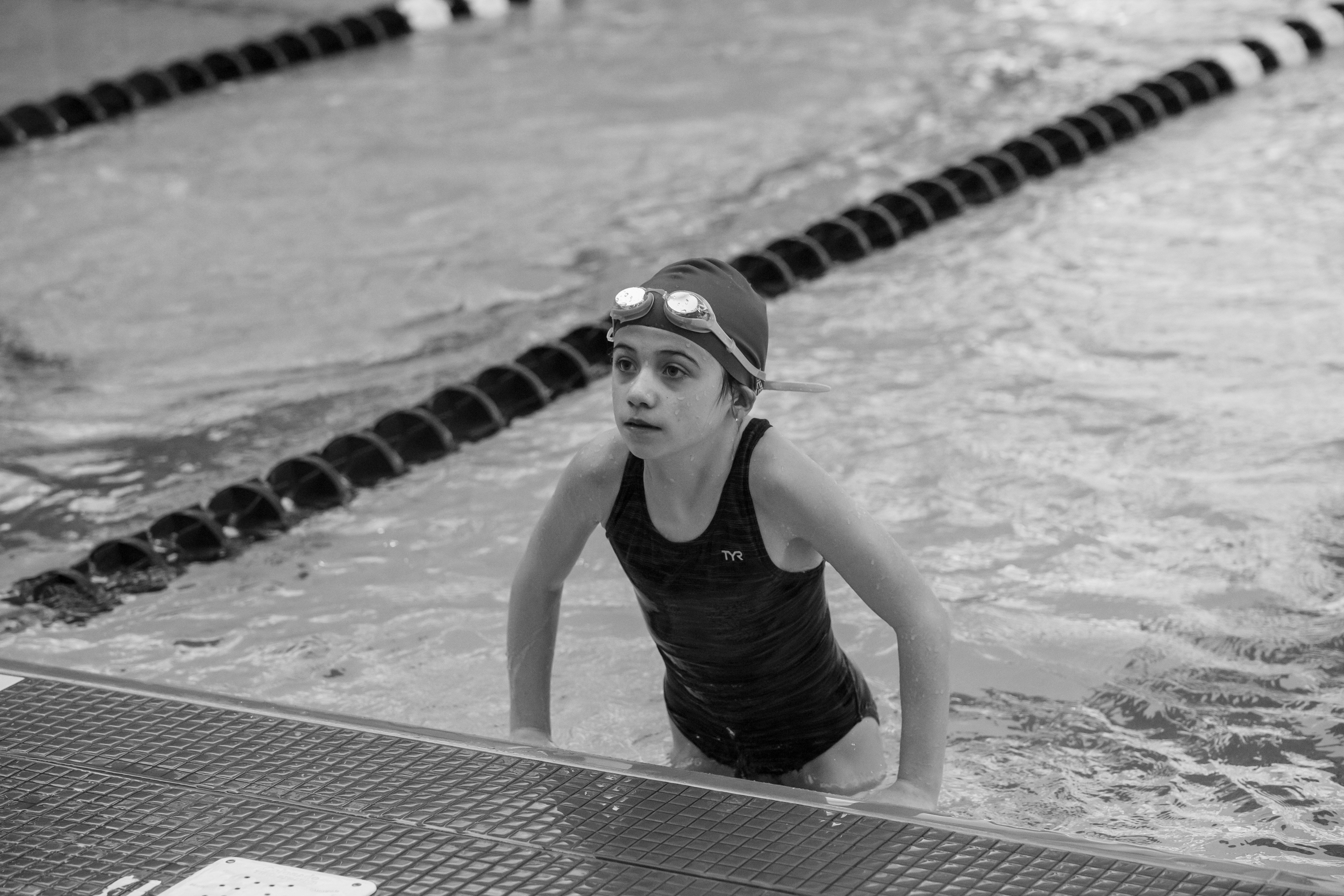 a girl in a swimming cap is in the water