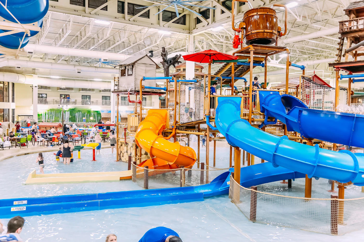 A large colorful indoor waterpark with slides and a play structure