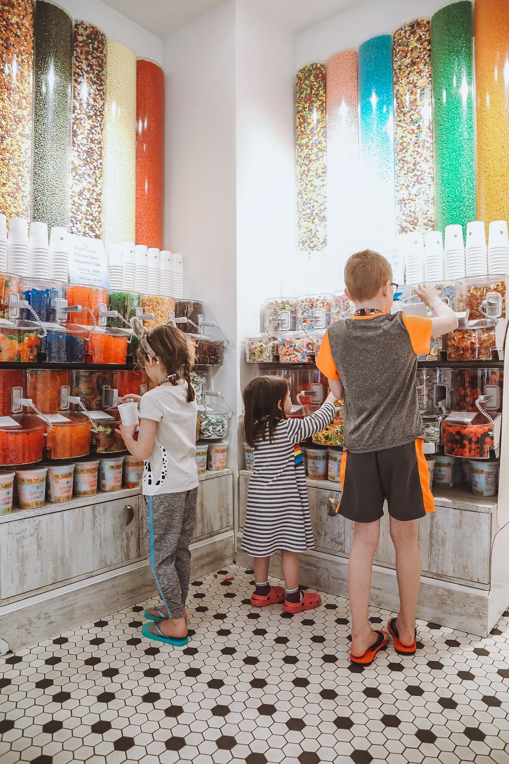 a couple of kids standing in front of a store