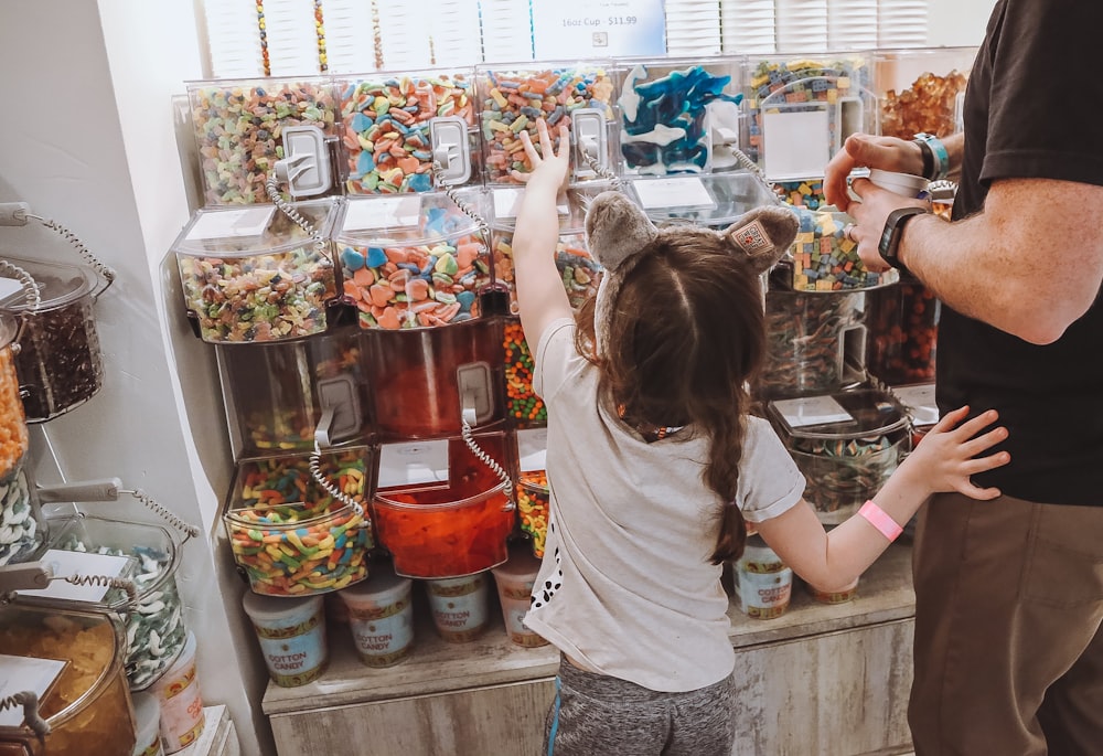 a man and a little girl standing in front of a store