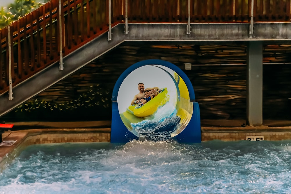 a man riding a banana boat on top of a body of water