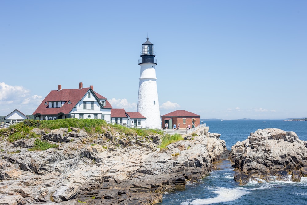 a light house sitting on top of a cliff next to the ocean