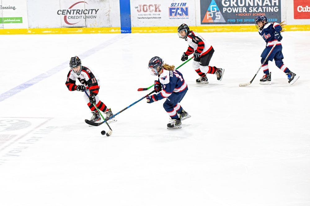 a group of people playing a game of ice hockey