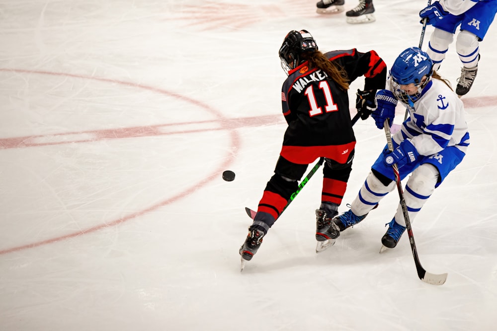 a group of people playing a game of ice hockey