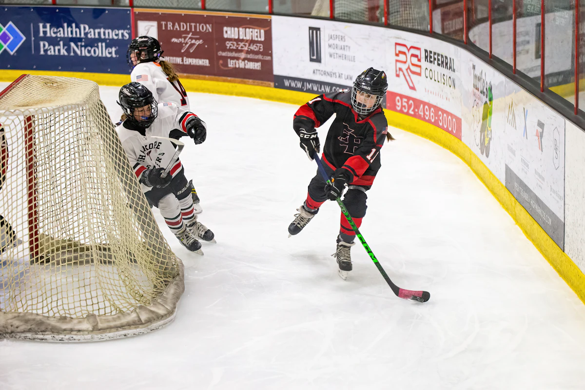 Two children playing ice hockey