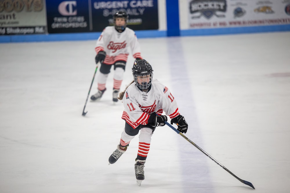 a group of young people playing a game of ice hockey