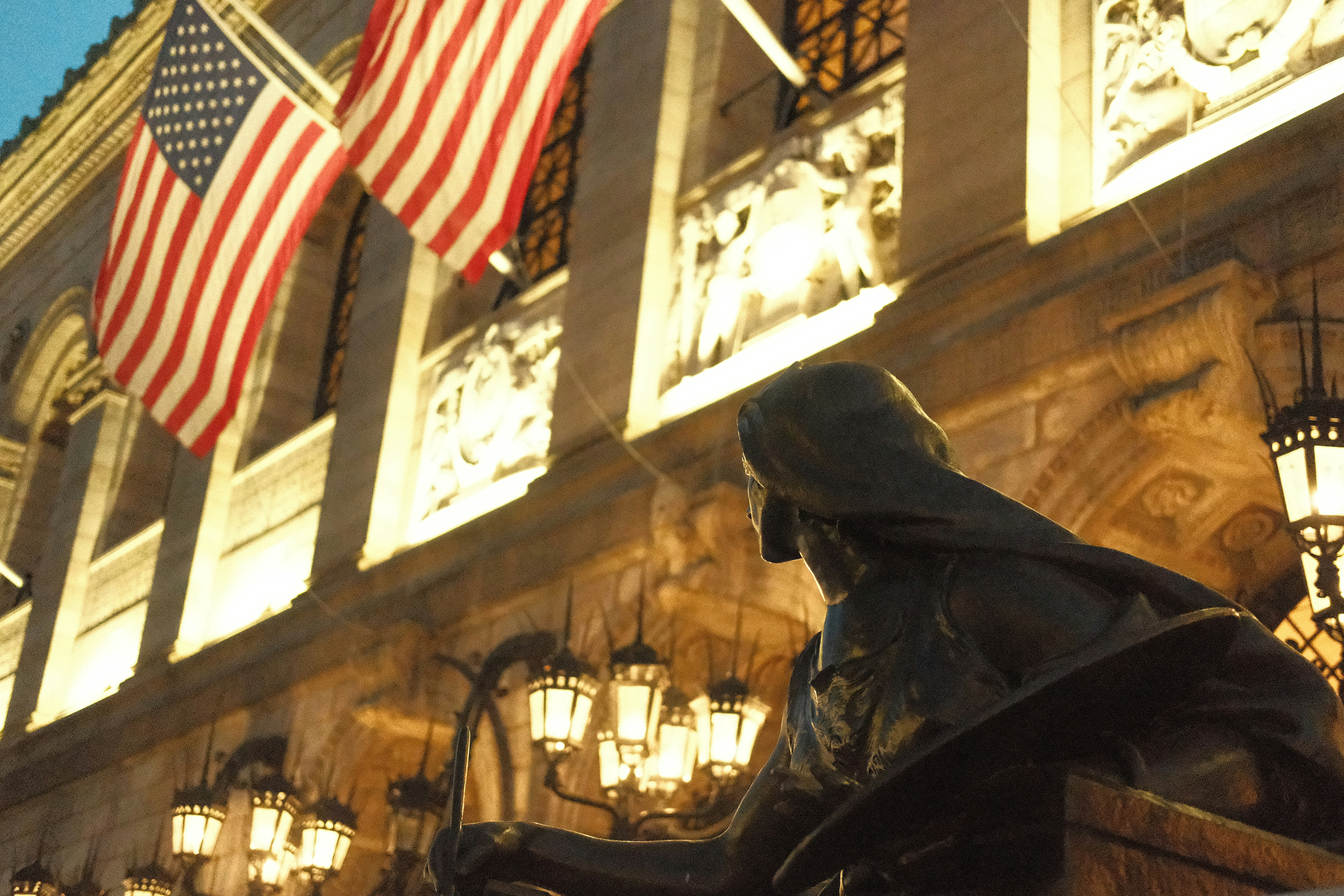 a statue of a man sitting in front of a building