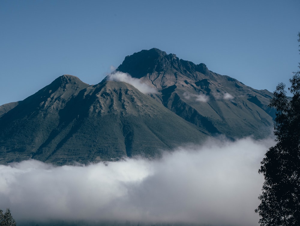 a mountain covered in clouds in the distance