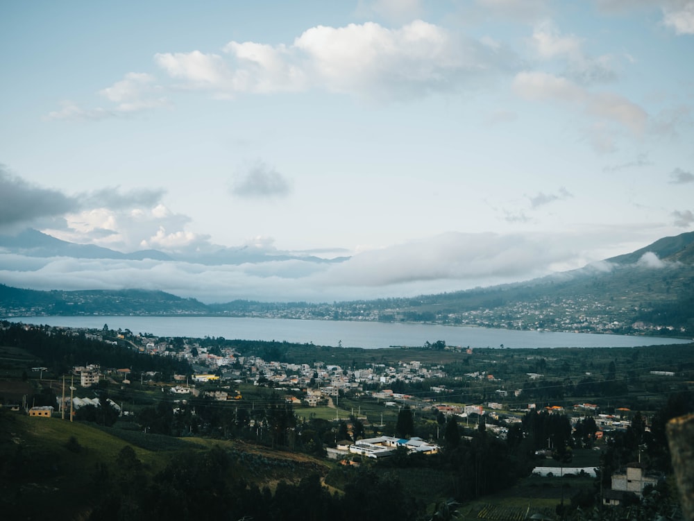 a scenic view of a town and a body of water