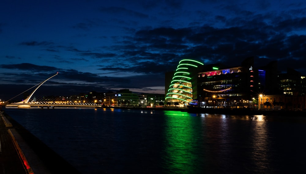 a night time view of a river and a bridge