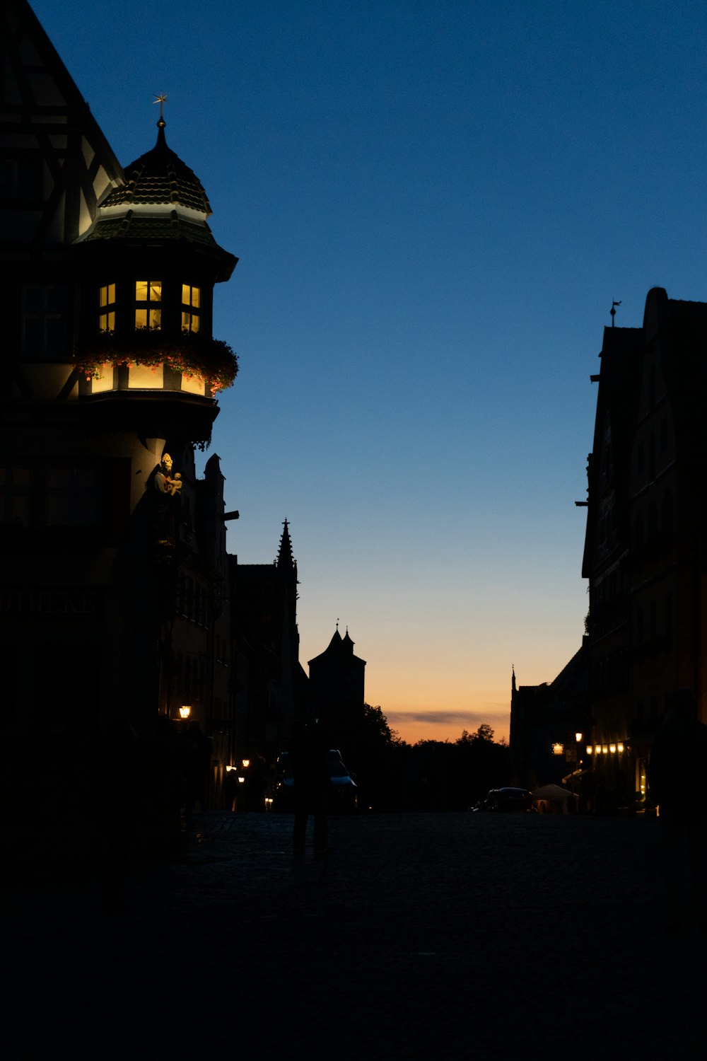 a person walking down a street at night