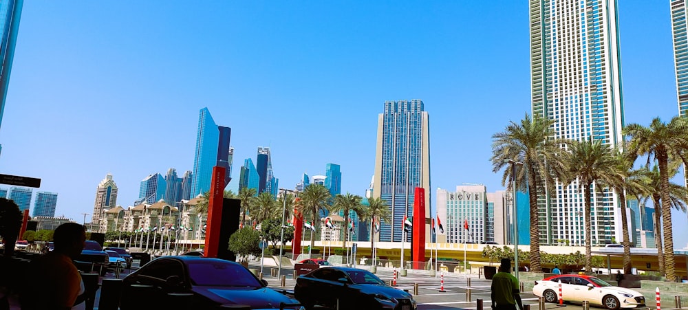a group of cars parked in front of tall buildings
