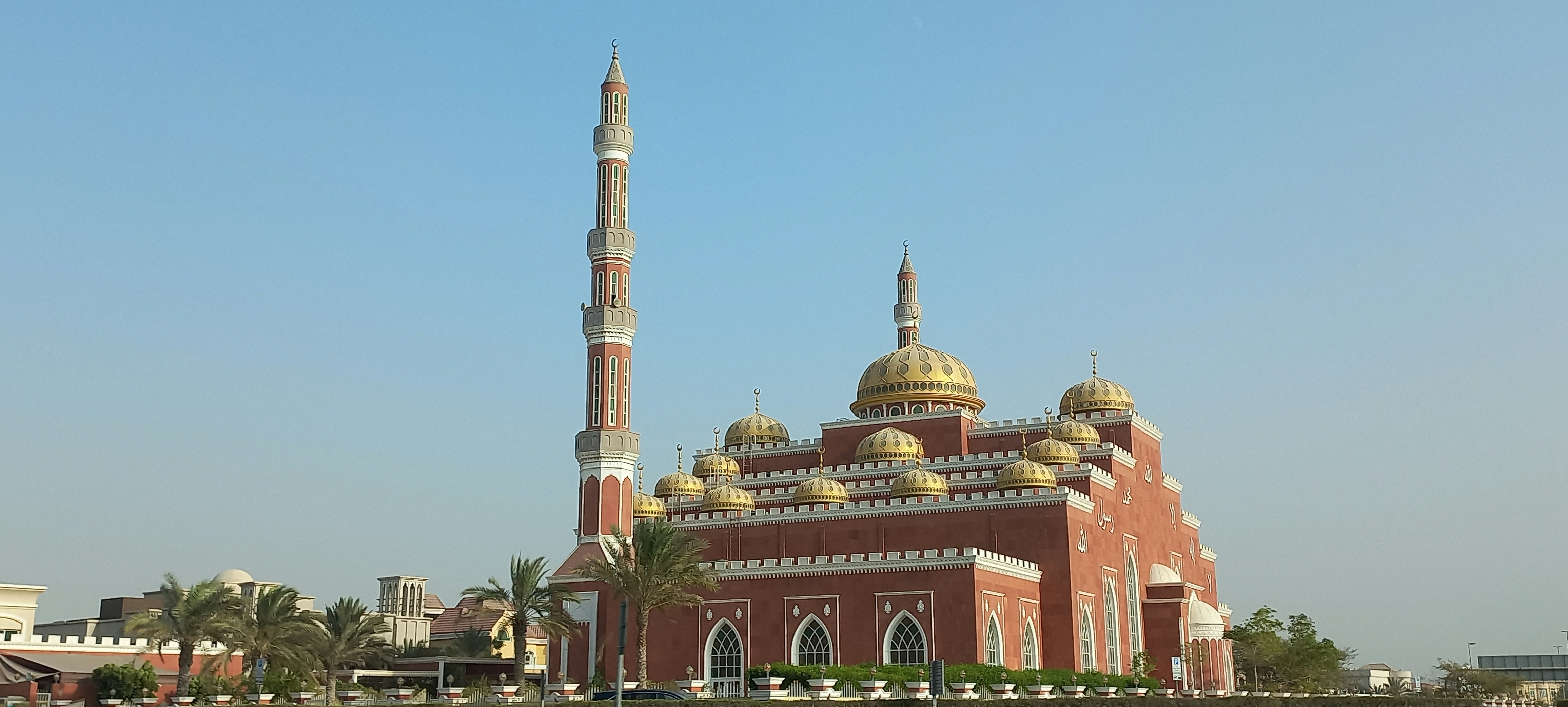 a large building with a tall tower in the middle of a city