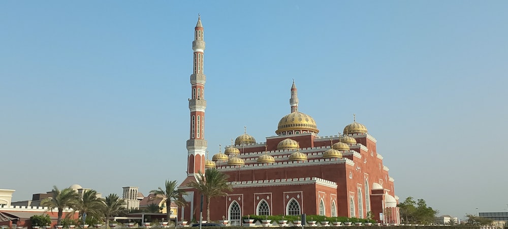 a large building with a tall tower in the middle of a city