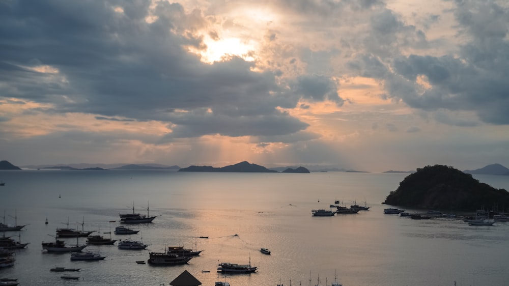 a harbor filled with lots of boats under a cloudy sky