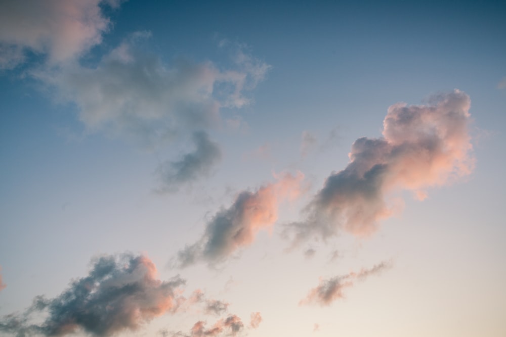 a plane flying in the sky with a lot of clouds