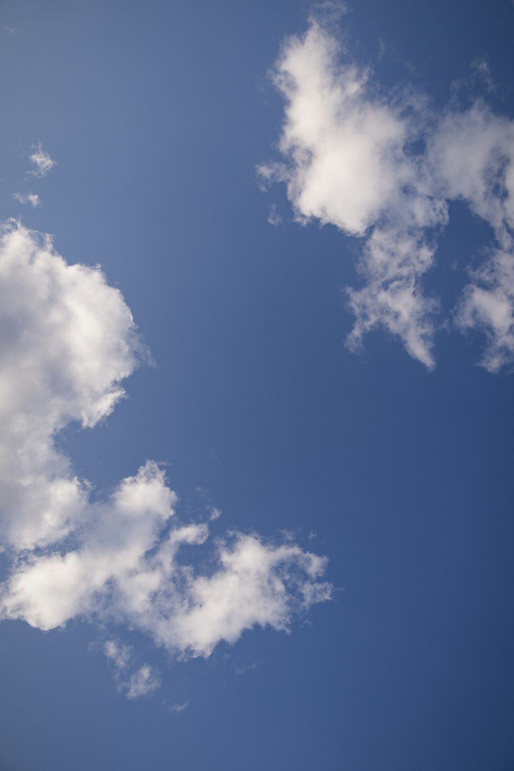 a plane flying in the sky with clouds