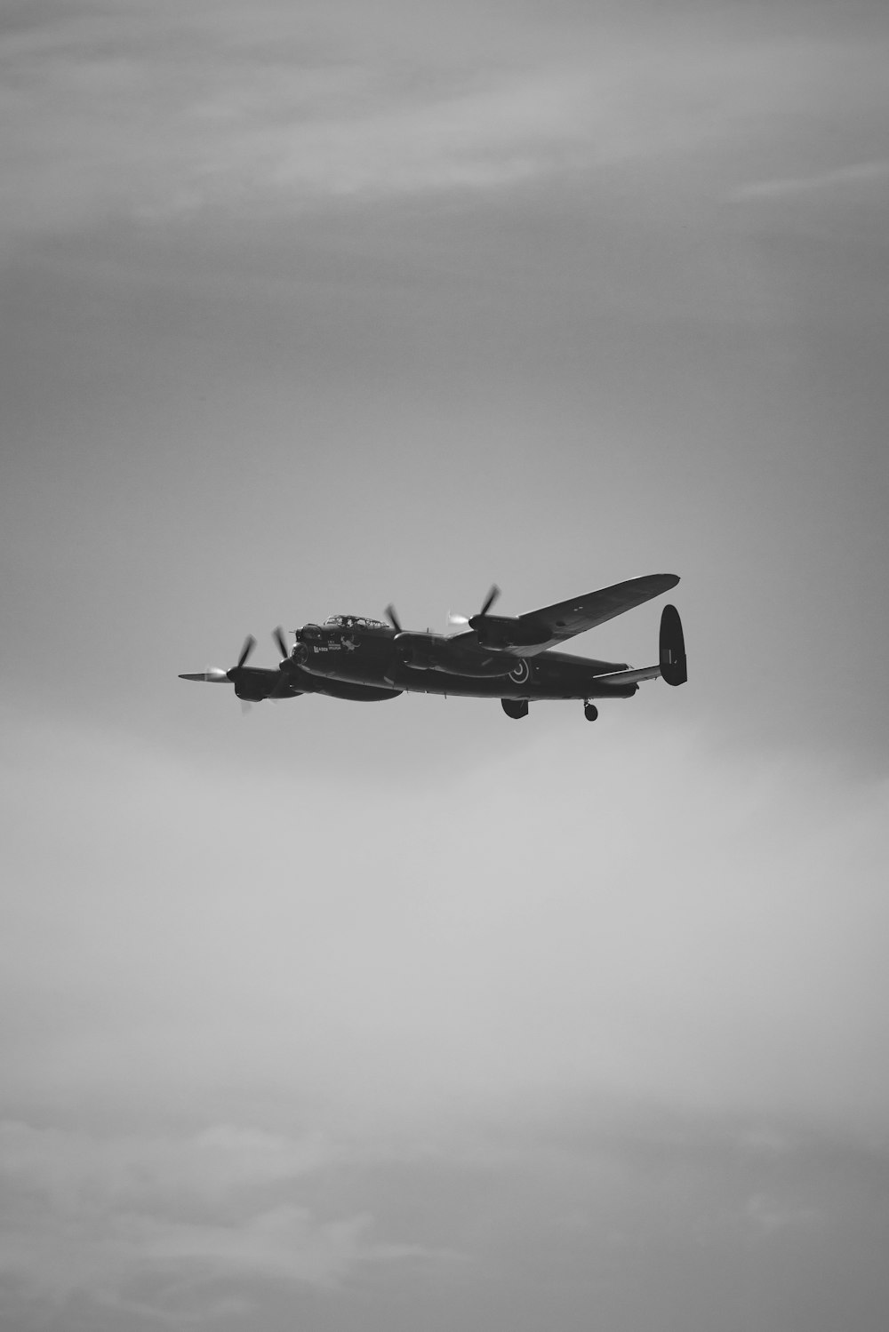 a plane flying in the air with a sky background