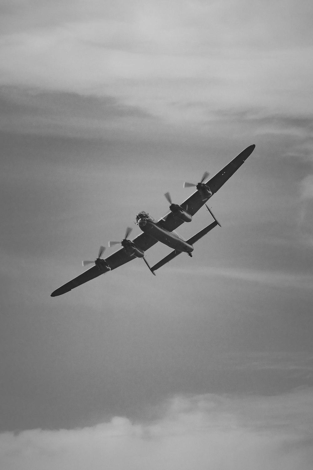 a small airplane flying through a cloudy sky