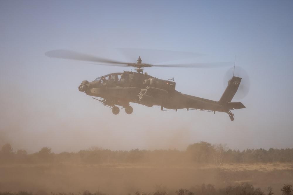 a helicopter is flying low over a field