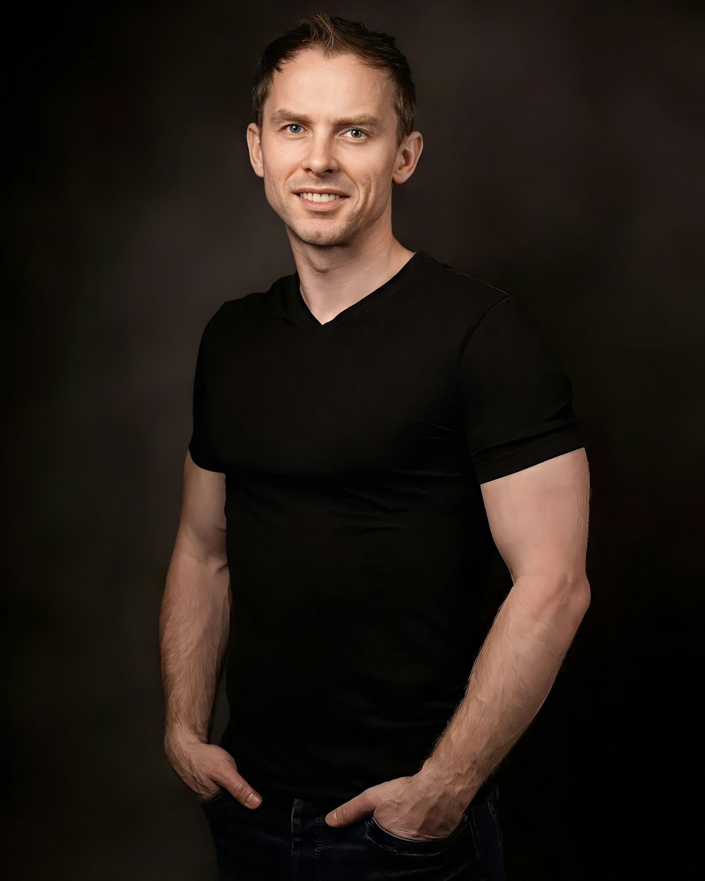 a man in a black shirt posing for a picture