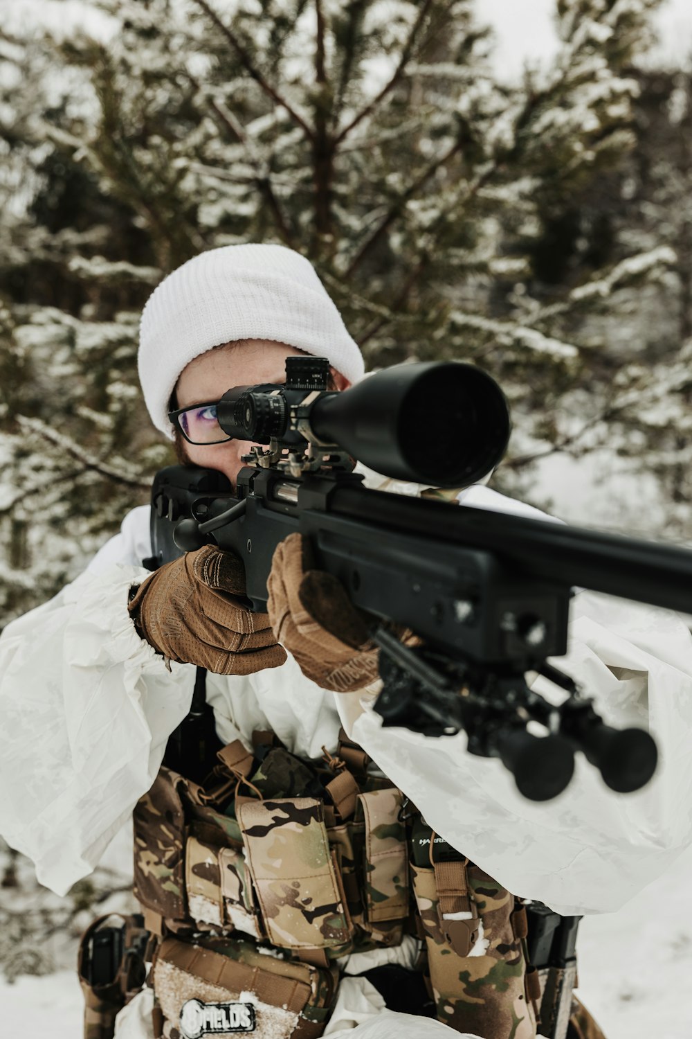 a man holding a rifle in the snow