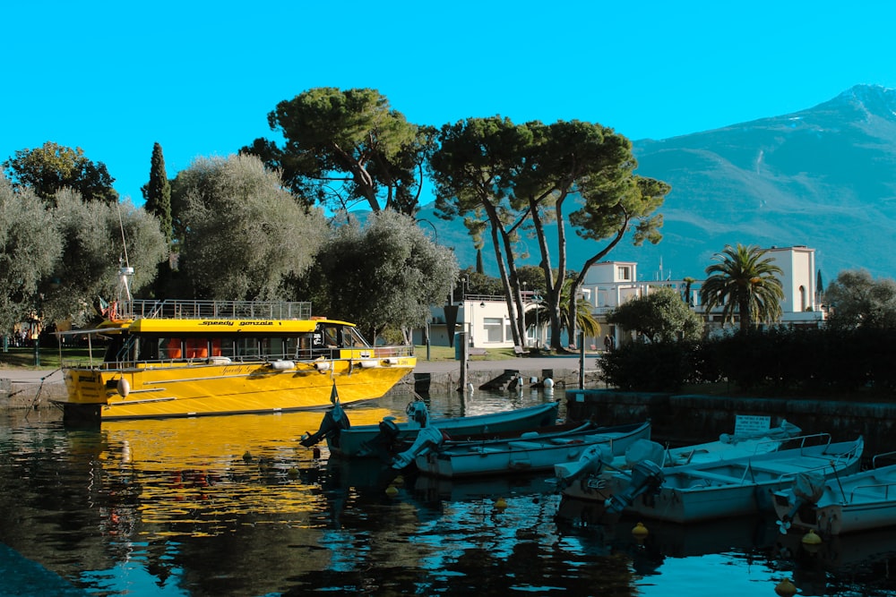 a yellow boat is in the water near some trees