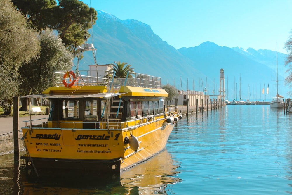 a yellow boat is docked at a dock