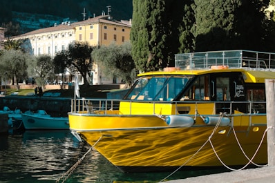 a yellow boat is docked in the water