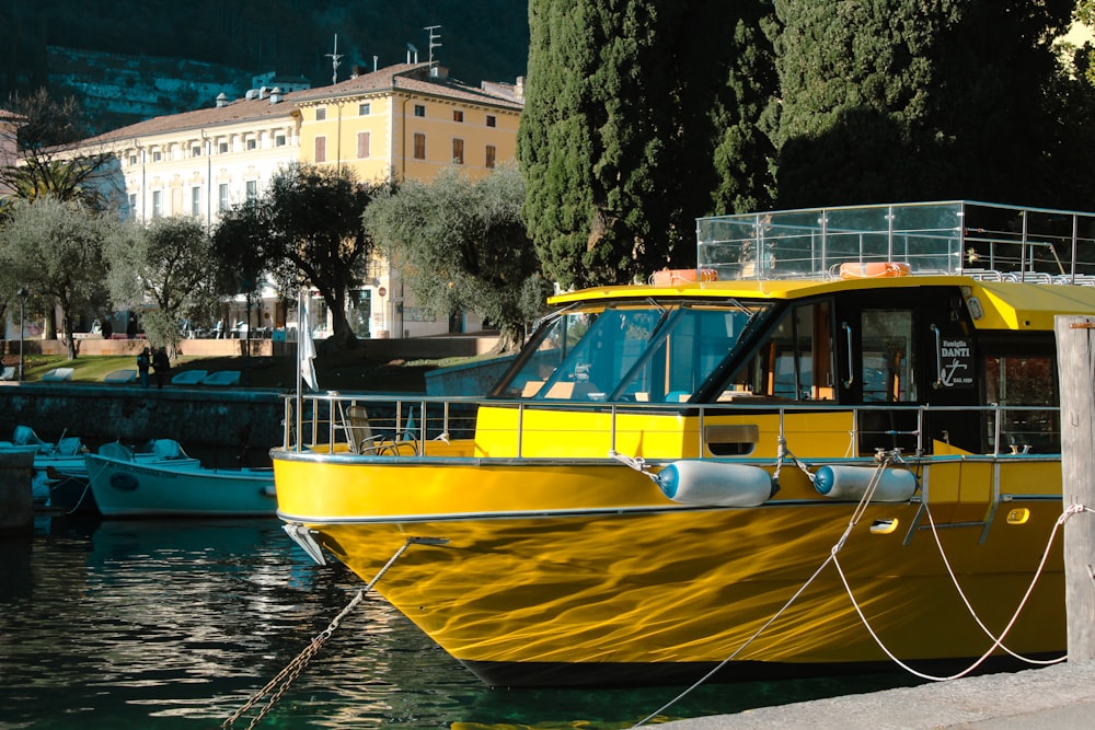 a yellow boat is docked in the water