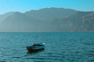 a small boat floating on top of a large body of water
